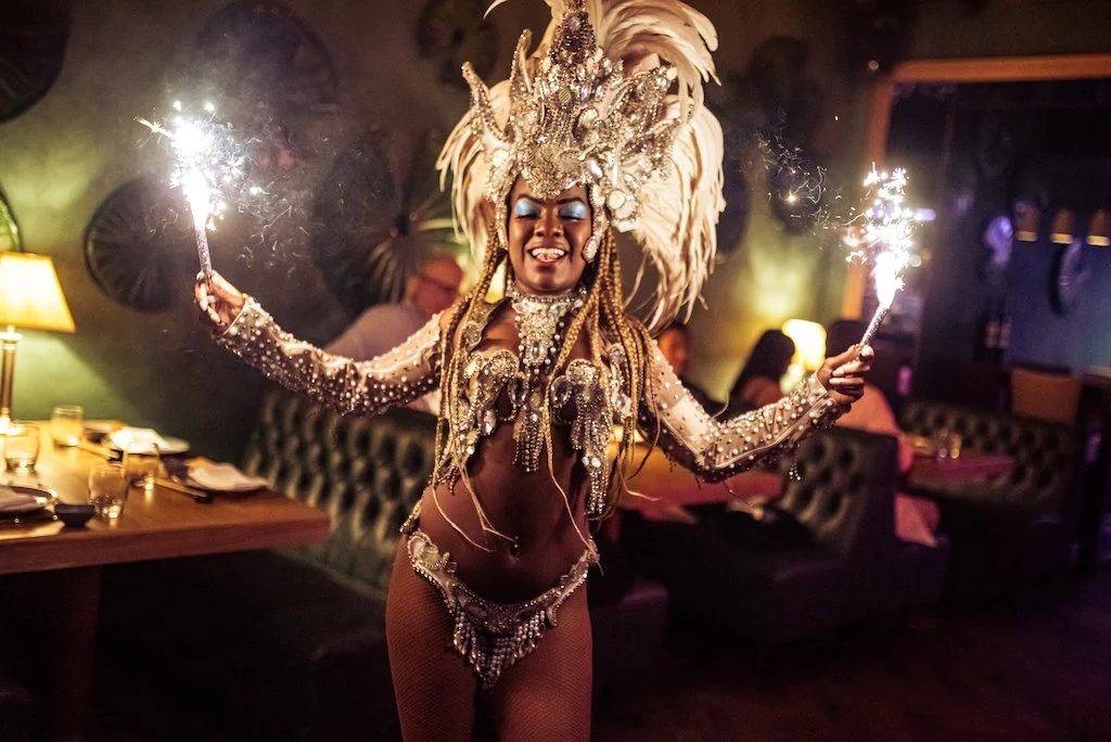 Samba dancer performing with sparklers between the tables at Ayllu in Paddington