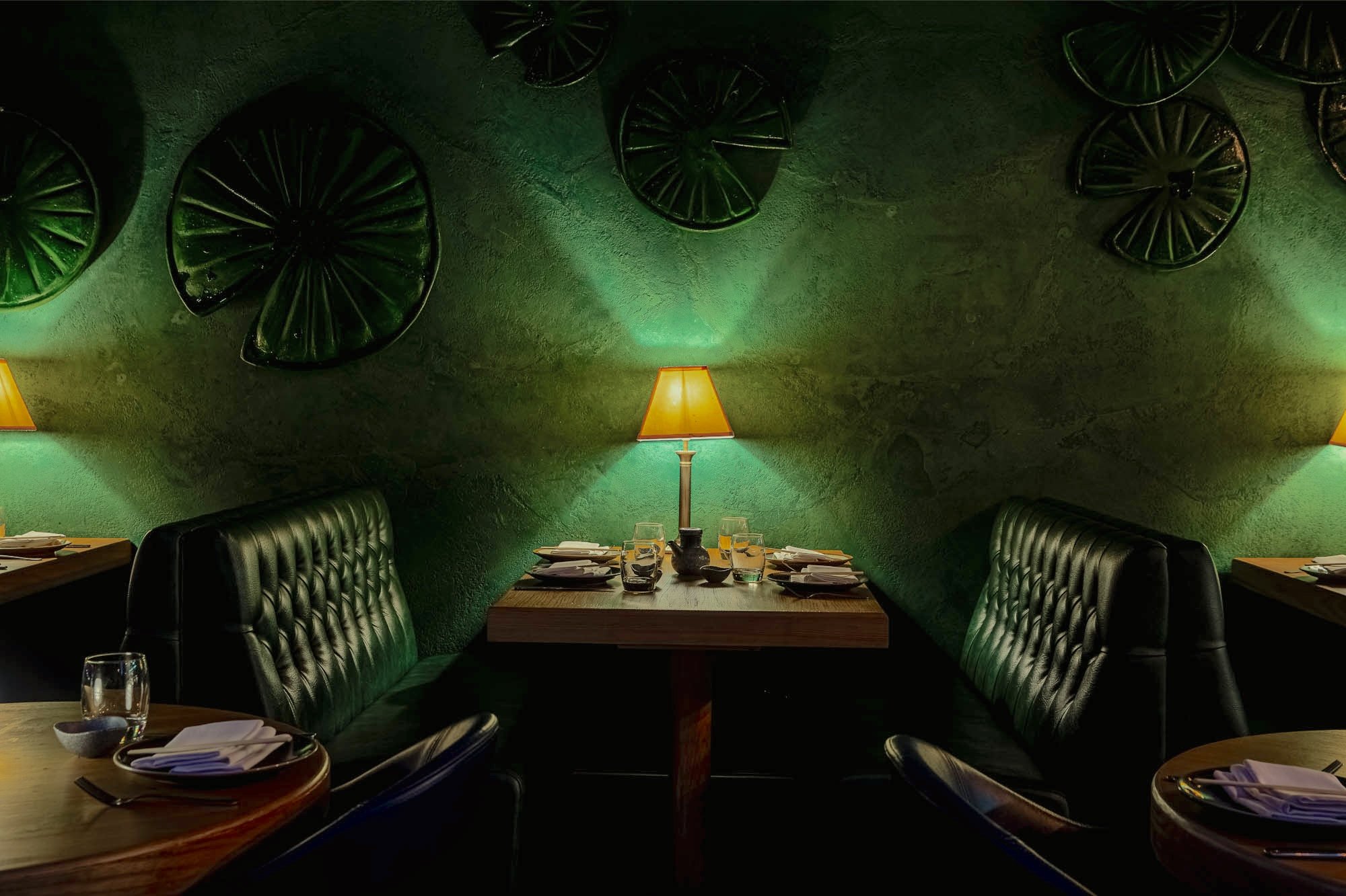 Dark-walled dining room with plush banquettes at Ayllu restaurant, Paddington