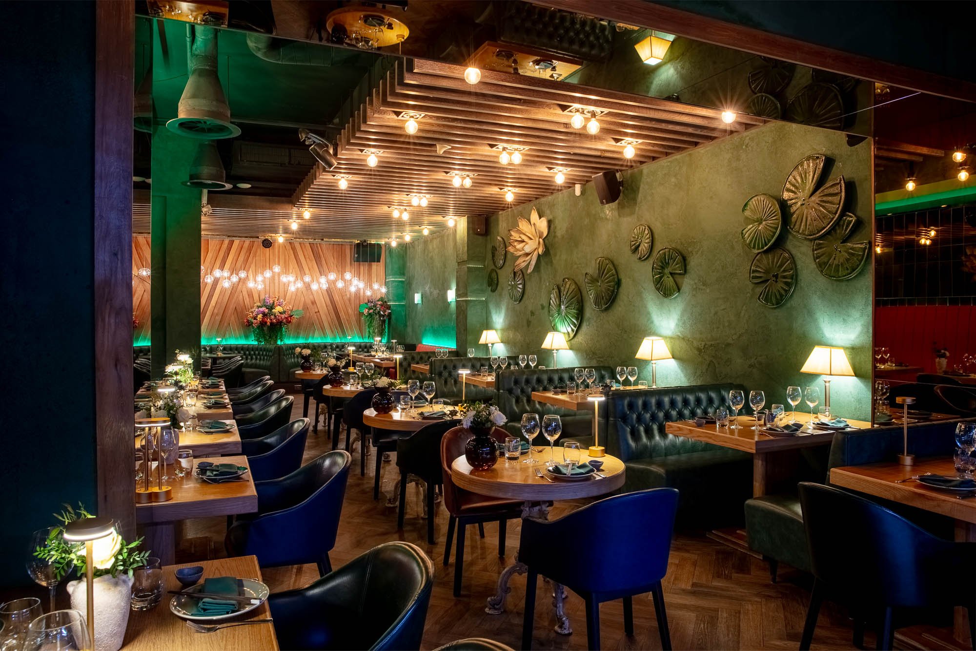 Dark-walled dining room with plush banquettes at Ayllu restaurant, Paddington